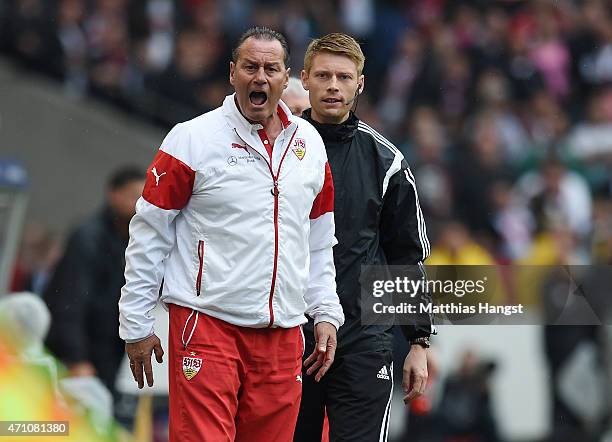 Head coach Huub Stevens of Stuttgart gestures next to the fourth referee Christian Dingert during the Bundesliga match between VfB Stuttgart and SC...