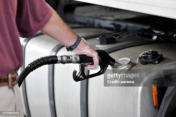 man filling up the gas tank with gasoline - diesel stock pictures, royalty-free photos & images