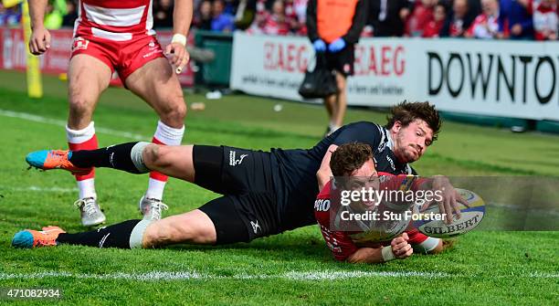 Gloucester player Billy Burns scores the winning try despite the attentions of Adam Powell during the Aviva Premiership match between Gloucester...