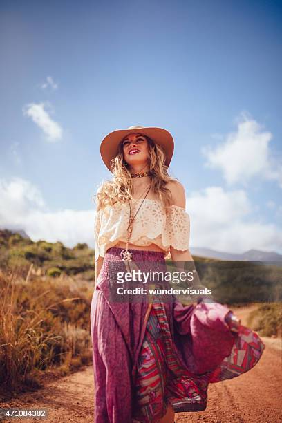 boho girl on a dirt road in a purple skirt - boehmen stock pictures, royalty-free photos & images