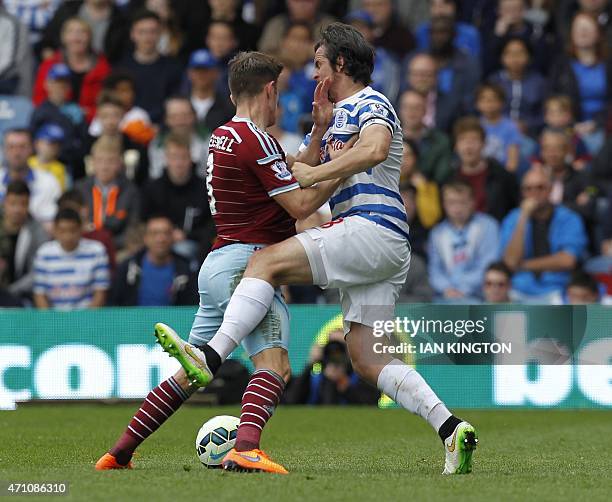 West Ham United's English defender Aaron Cresswell vies with Queens Park Rangers English midfielder Joey Barton during the English Premier League...