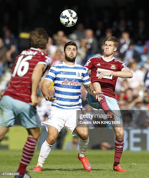 Queens Park Rangers English striker Charlie Austin vies with West Ham United's English defender Reece Burke during the English Premier League...