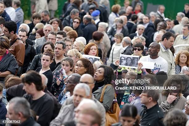 Young girl holds portraits of Aurelie Chatelain, who was found dead on April 19, 2015 in Villejuif, during a march in homage to Chatelain on April...