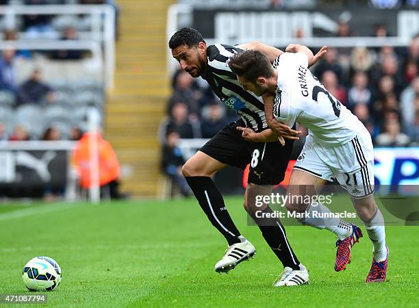 Jonas Gutierrez of Newcastle is tackled by Matt Grimes of Swansea City during the Barclays Premier League match between Newcastle United and Swansea...