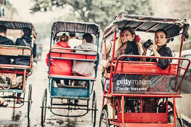 tourists in a rickshaw - india tourism stockfoto's en -beelden