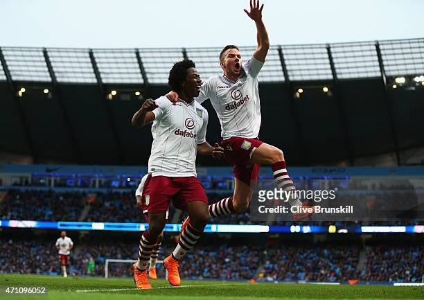 Tom Cleverley of Aston Villa celebrates with goalscorer Carlos Sanchez during the Barclays Premier League match between Manchester City and Aston...