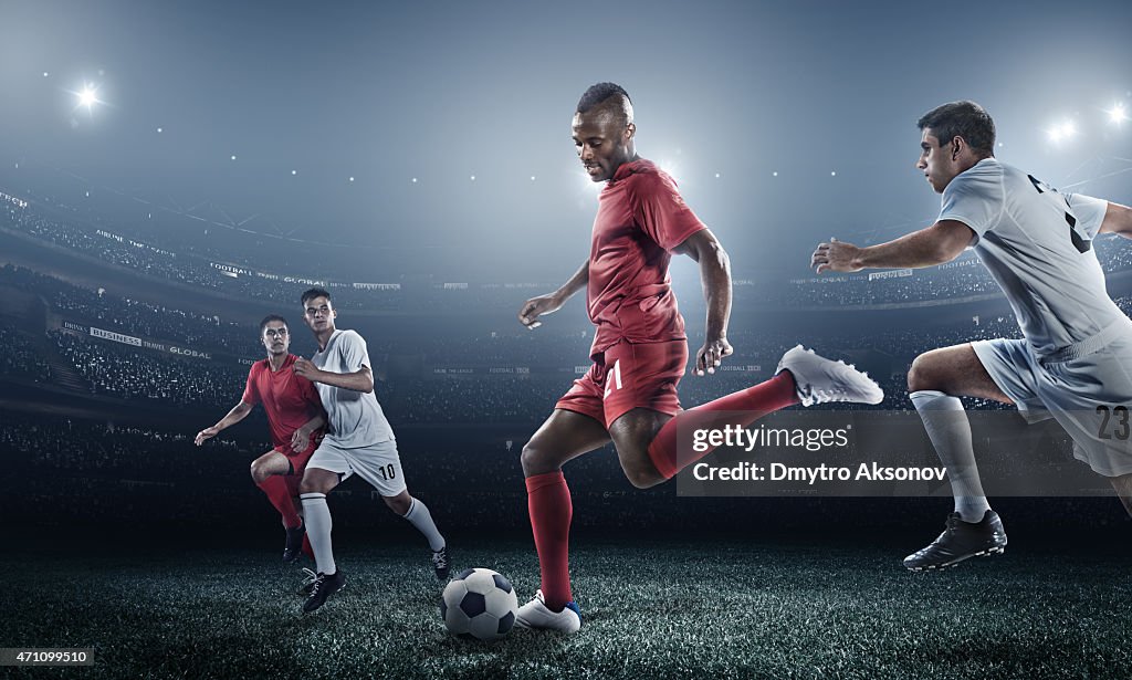 Soccer player kicking ball in stadium