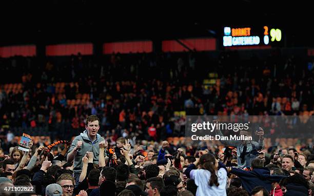 Barnet fans invade the pitch after the final whistle as their team win promotion during the Vanarama Football Conference League match between Barnet...