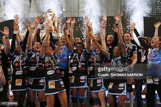 Metz's players celebrate with the cup after winning the Women's Handball French Cup final against Nimes HBC in Paris, on April 25, 2015. AFP PHOTO /...