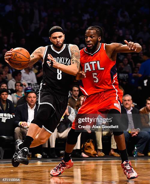 Deron Williams of the Brooklyn Nets attempts to drive past DeMarre Carroll of the Atlanta Hawks during the first round of the 2015 NBA Playoffs at...
