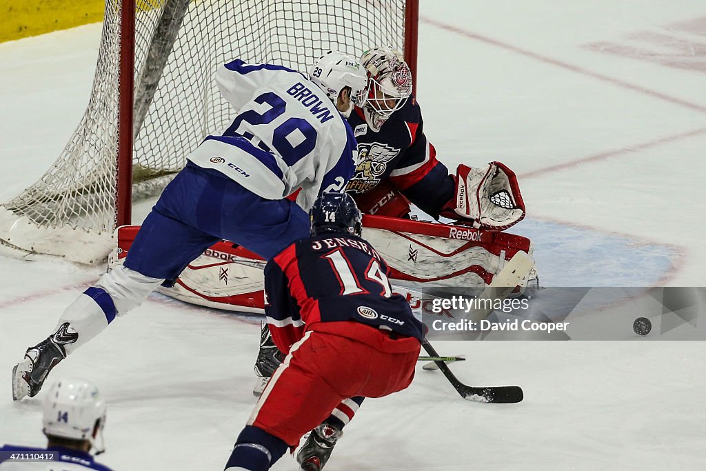 Marlies Connor Brown (29) works in front of Griffins Goalie Tom McCollum (30) as they fight for the puck