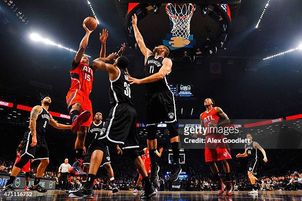 Al Horford of the Atlanta Hawks shoots over Thaddeus Young and Brook Lopez of the Brooklyn Nets during the first round of the 2015 NBA Playoffs at...