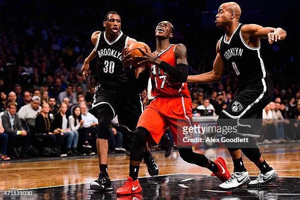 Dennis Schroder of the Atlanta Hawks attempts to drive between Thaddeus Young and Jarrett Jack of the Brooklyn Nets in Game Three during the first...