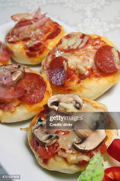 mini pizzas - mini pizza stock pictures, royalty-free photos & images