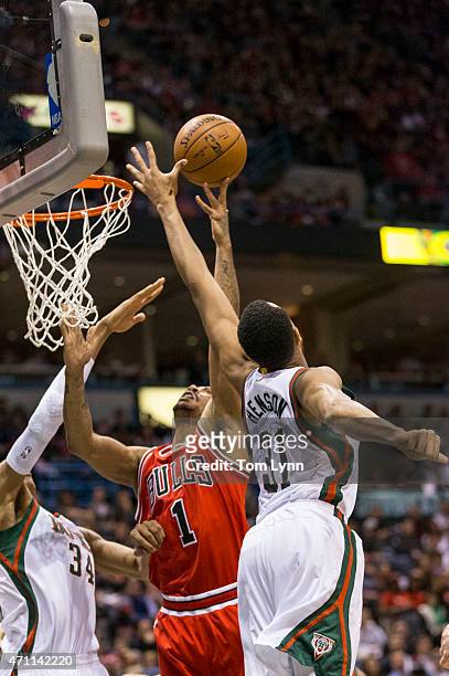 Guard Derrick Rose of the Chicago Bulls has his shot blocked by center John Henson of the Milwaukee Bucks in the second quarter of game four of the...