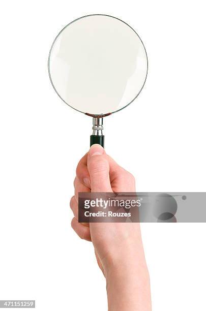 magnifying glass in hand - lupe stock pictures, royalty-free photos & images