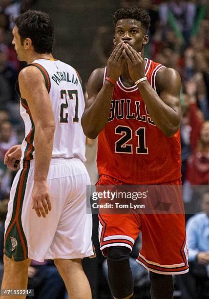 Guard Jimmy Butler of the Chicago Bulls reacts to hitting a three pointer against the the Milwaukee Bucks in the third quarter of game four of the...