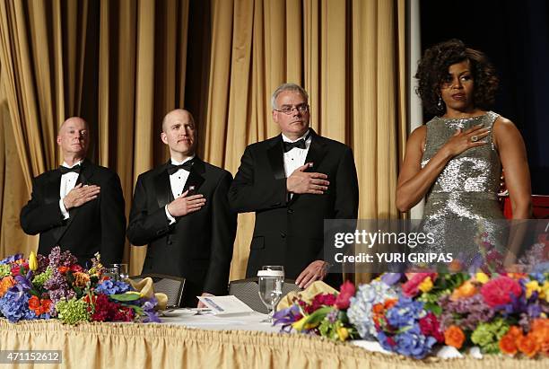 First Lady Michelle Obama stands in a attention during a national anthem at the White House Correspondents' Association Dinner in Washington, DC on...