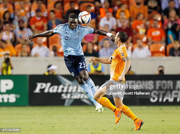 Jalil Anibaba of Sporting KC battles for the ball with Brad Davis of Houston Dynamo duirng their game at BBVA Compass Stadium on April 25, 2015 in...