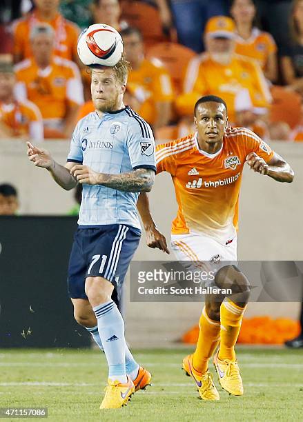 Marcel de Jong of Sporting KC battles for the ball with Ricardo Clark of Houston Dynamo duirng their game at BBVA Compass Stadium on April 25, 2015...