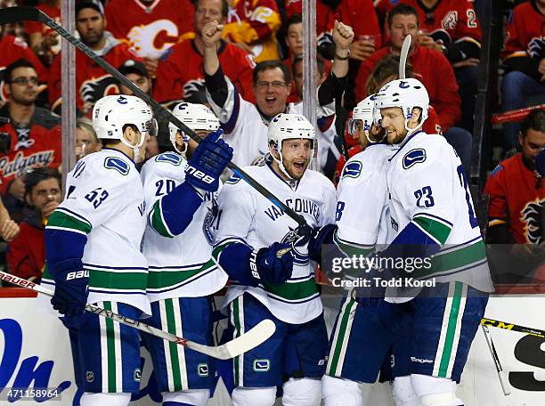 Bo Horvat, Chris Higgins, Brandon McMillan, Christopher Tanev and Alexander Edler of the Vancouver Canucks celebrate McMillian's goal against the...