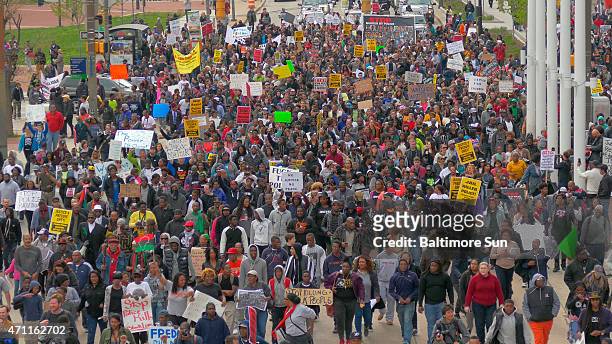 Large protest heads east on Pratt Street in Baltimore on Saturday, April 25 as protests continue in the wake of Freddie Gray's death while in police...