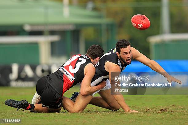 Brenden Abbott of the Collingwood Magpies and Kurt Aylett of the Essendon Bombers contest the ball during the round two VFL match between the...