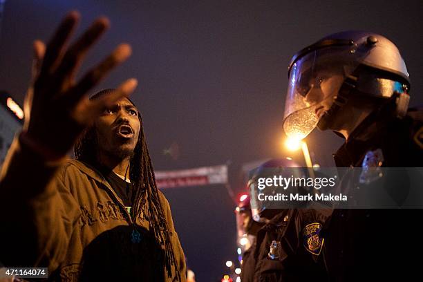 Protester confronts police in riot gear following a gathering in honor of Freddie Gray April 25, 2015 in Baltimore, Maryland. Freddie Gray was...