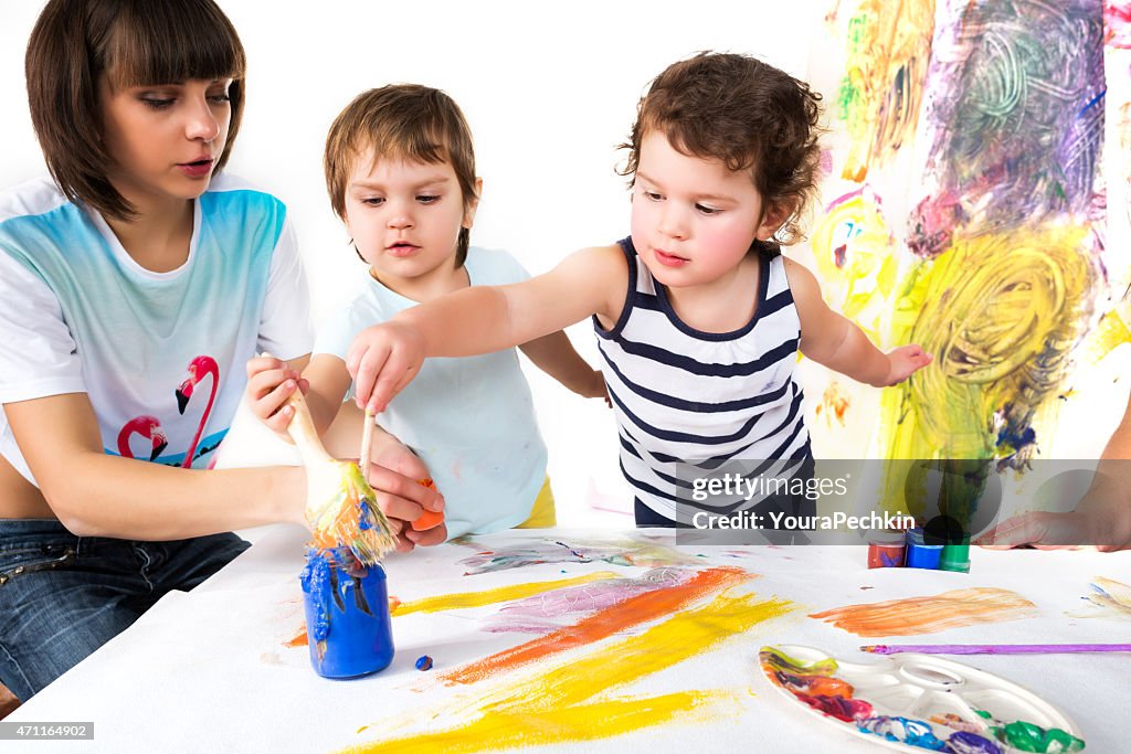 Small children draw paints around