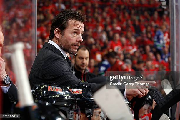 Assistant coach Martin Gelinas of the Calgary Flames gives instructions to his players on the bench against the Vancouver Canucks at Scotiabank...