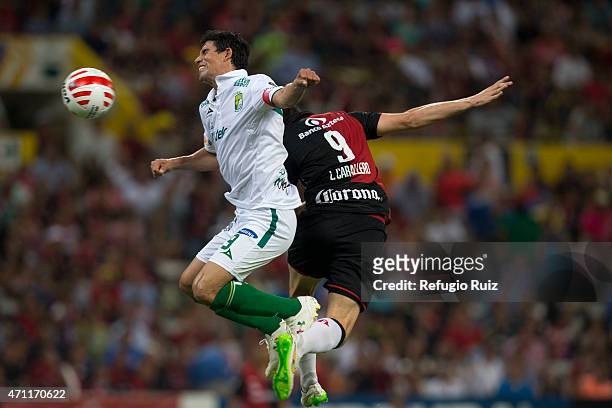 Nery Caballero of Atlas jumps for the ball with Jonny Magallon of Leon during a match between Atlas and Leon as part of 15th round of Clausura 2015...