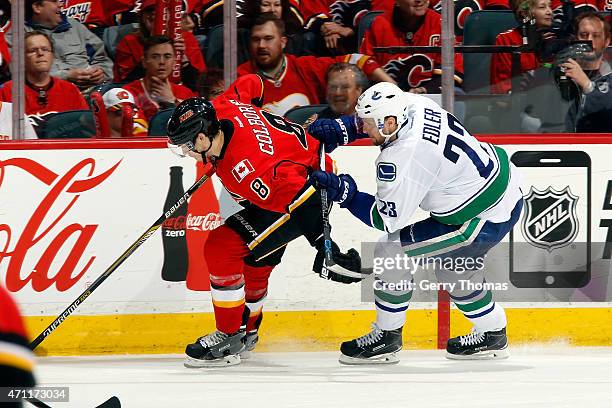 Joe Colborne of the Calgary Flames skates against Alex Edler of the Vancouver Canucks at Scotiabank Saddledome for Game Six of the Western...