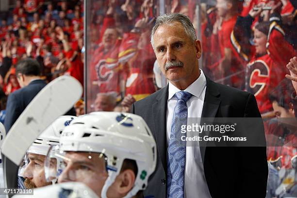 Head coach Willie Desjardins of the Vancouver Canucks watches the game against the Calgary Flames at Scotiabank Saddledome for Game Six of the...