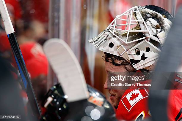 Karri Ramo of the Calgary Flames takes a break at the bench during a stoppage in play against the Vancouver Canucks at Scotiabank Saddledome for Game...