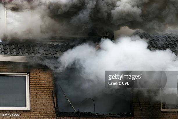 picture of a house consumed in smoke and fire - damaged stock pictures, royalty-free photos & images