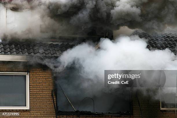 picture of a house consumed in smoke and fire - damaged house stock pictures, royalty-free photos & images