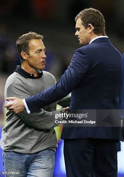 Hawks head coach Alastair Clarkson shakes hands with Fox Footy commentator Cameron Mooney after being interviewed by television commentators during...