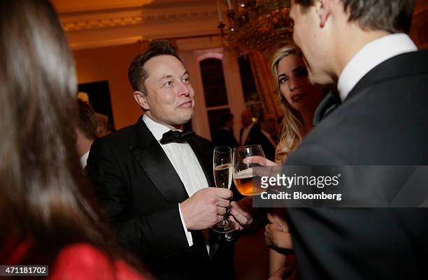 Billionaire Elon Musk, co-founder and chief executive officer of Tesla Motors Inc., center left, and Ivanka Trump, executive vice president of...