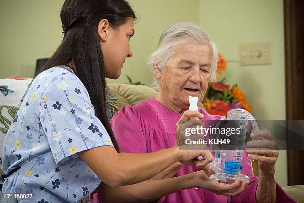 breathing test of senior man by a nurse for a lung condition - breath test stockfoto's en -beelden
