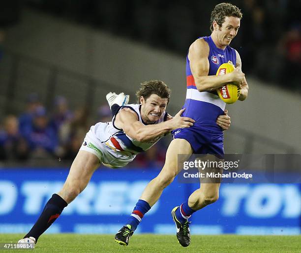 Patrick Dangerfield of the Crows tackles Robert Murphy of the Bulldogs during the round four AFL match between the Western Bulldogs and the Adelaide...