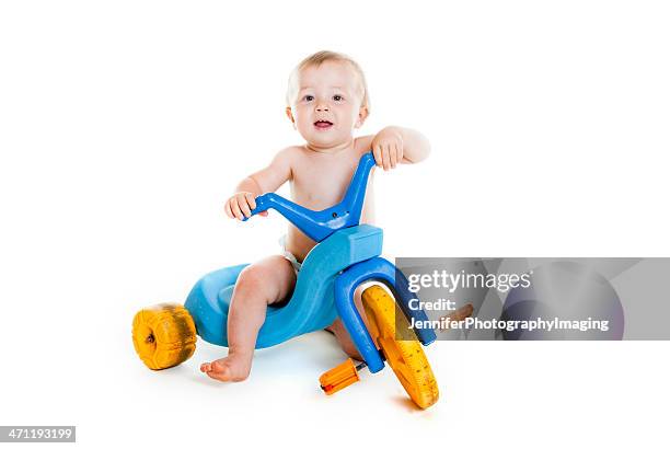 baby boy on a trike - tricycle stock pictures, royalty-free photos & images