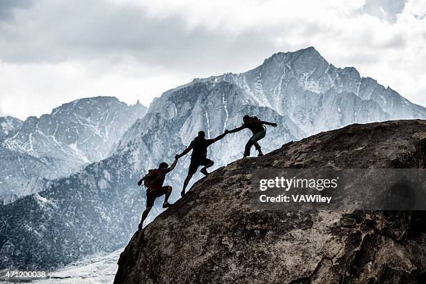 três amigos ajudando - montanhismo imagens e fotografias de stock
