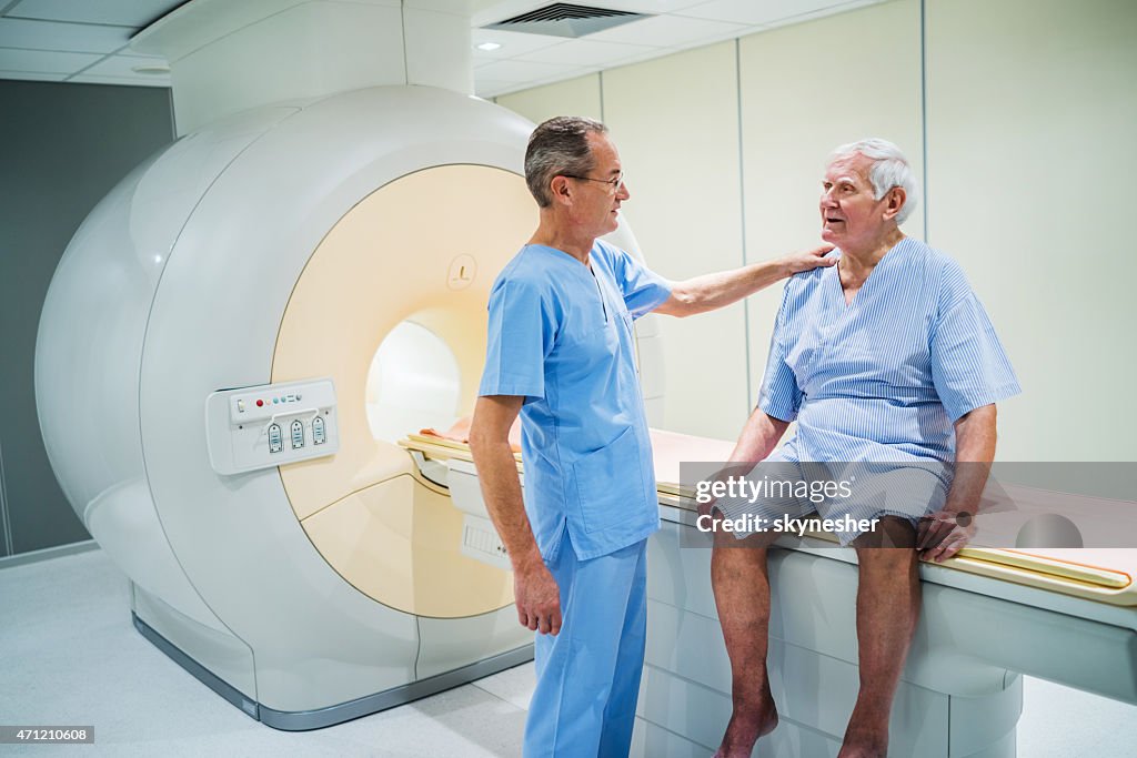 Radiologue d'âge mûr parler au patient senior.