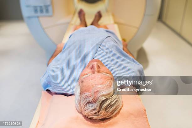 senior patient receiving an mri scan. - prostate cancer stock pictures, royalty-free photos & images