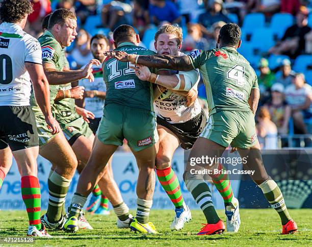 Rabbitohs George Burgess is tackled by a pair of Canberra defenders during the round eight NRL match between the South Sydney Rabbitohs and the...