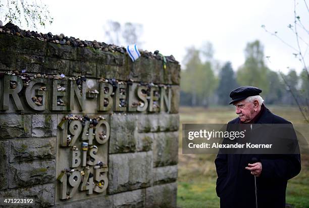 Contemporary witness stands in front of a memorial plaque during a ceremony to commemorate the 70th anniversary of the liberation of the...