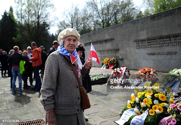 Contemporary witness looks on in front of a memorial plaque during a ceremony to commemorate the 70th anniversary of the liberation of the...