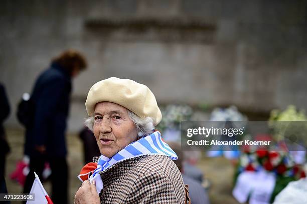 Contemporary witness looks on in front of a memorial plaque during a ceremony to commemorate the 70th anniversary of the liberation of the...