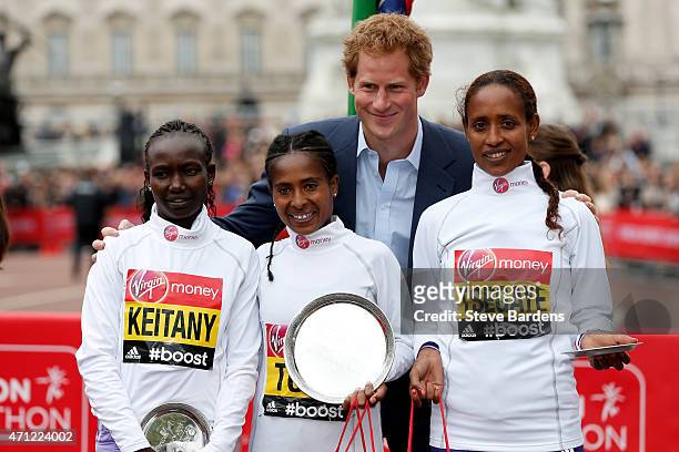 Second placed Mary Keitany of Kenya, first placed Tigist Tufa of Kenya, Prince Harry and third placed Tirfi Tsegaye of Ethiopia pose for the cameras...