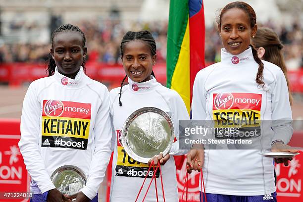 Second placed Mary Keitany of Kenya, first placed Tigist Tufa of Kenya and third placed Tirfi Tsegaye of Ethiopia pose for the cameras following the...